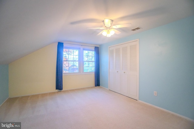 additional living space with lofted ceiling, light carpet, and ceiling fan