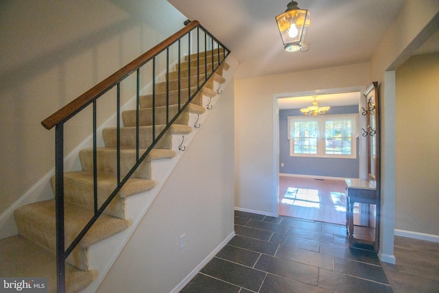 stairway with a chandelier