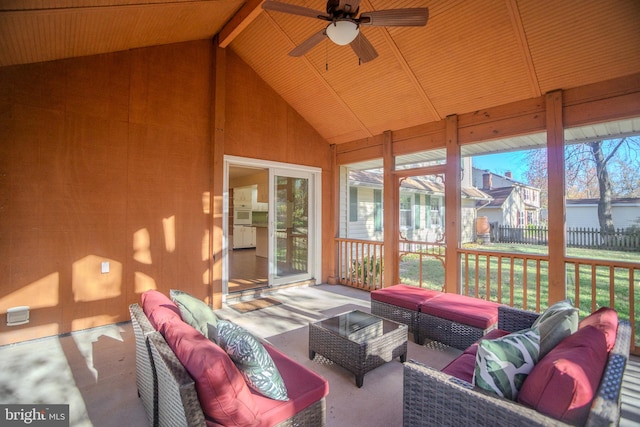 sunroom / solarium featuring lofted ceiling with beams and ceiling fan