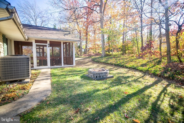 view of yard with central air condition unit and a sunroom