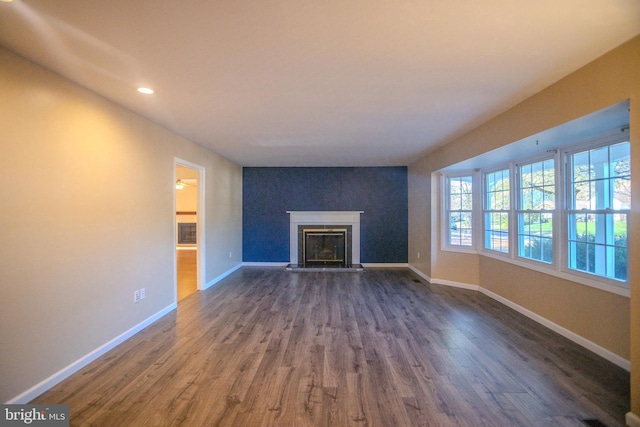 unfurnished living room featuring dark wood-type flooring