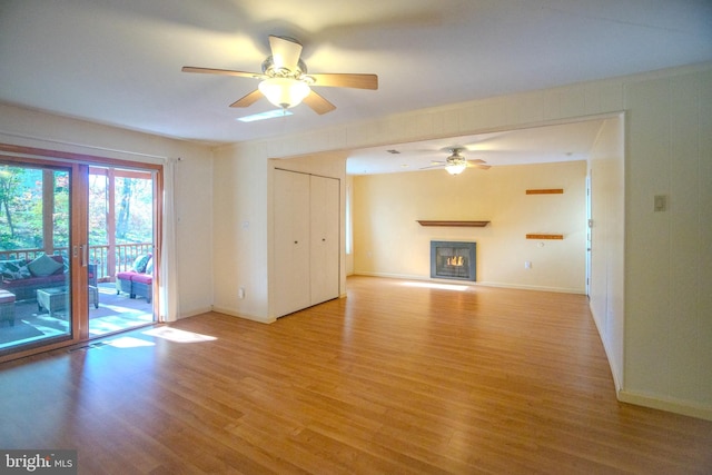 unfurnished living room with ceiling fan and light hardwood / wood-style floors