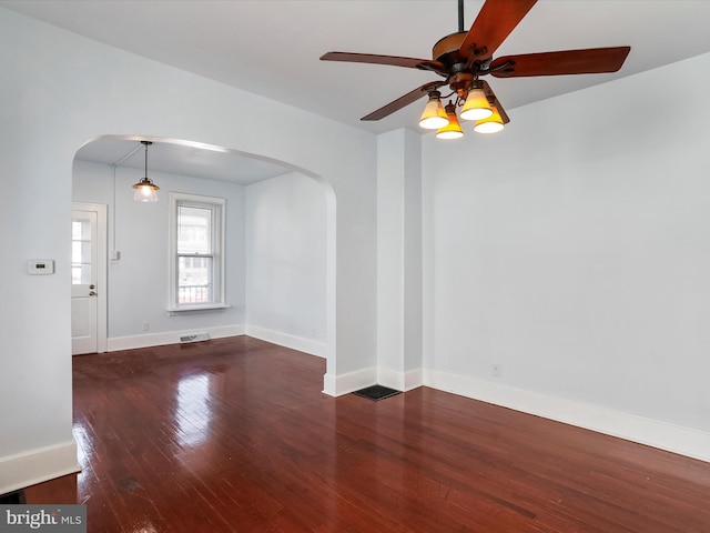 empty room featuring ceiling fan and dark hardwood / wood-style flooring