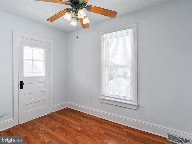 spare room with ceiling fan and wood-type flooring