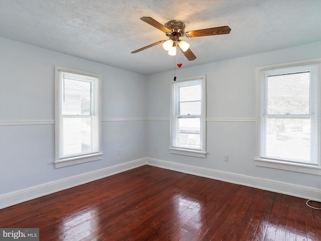 spare room with ceiling fan, a textured ceiling, and hardwood / wood-style floors