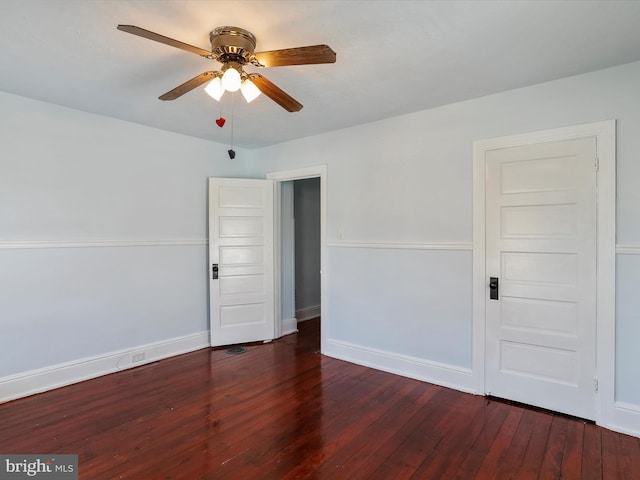 spare room featuring ceiling fan and dark hardwood / wood-style flooring