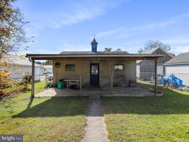 rear view of property with a patio and a lawn