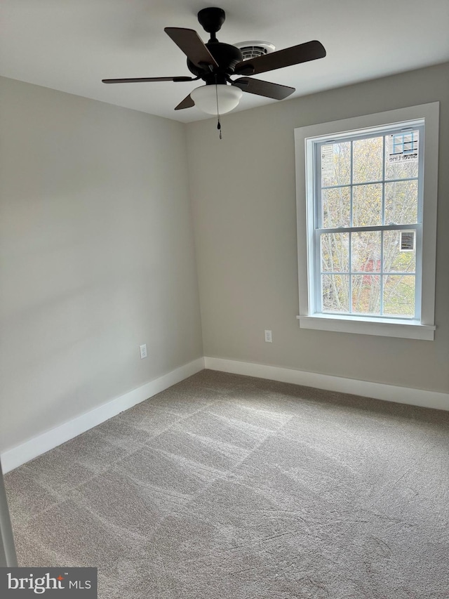 spare room featuring carpet flooring and ceiling fan