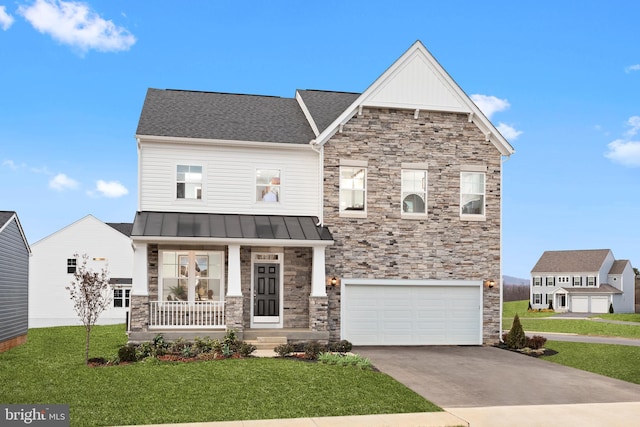 view of front of house featuring a front yard, a porch, and a garage