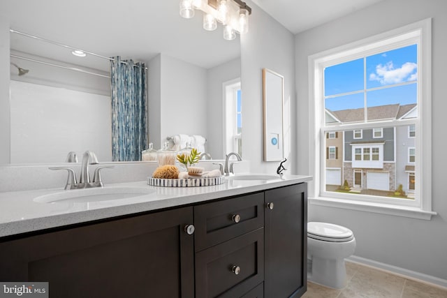 bathroom featuring vanity, toilet, tile patterned floors, and walk in shower