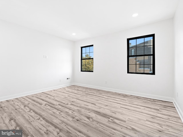 unfurnished room with light hardwood / wood-style flooring