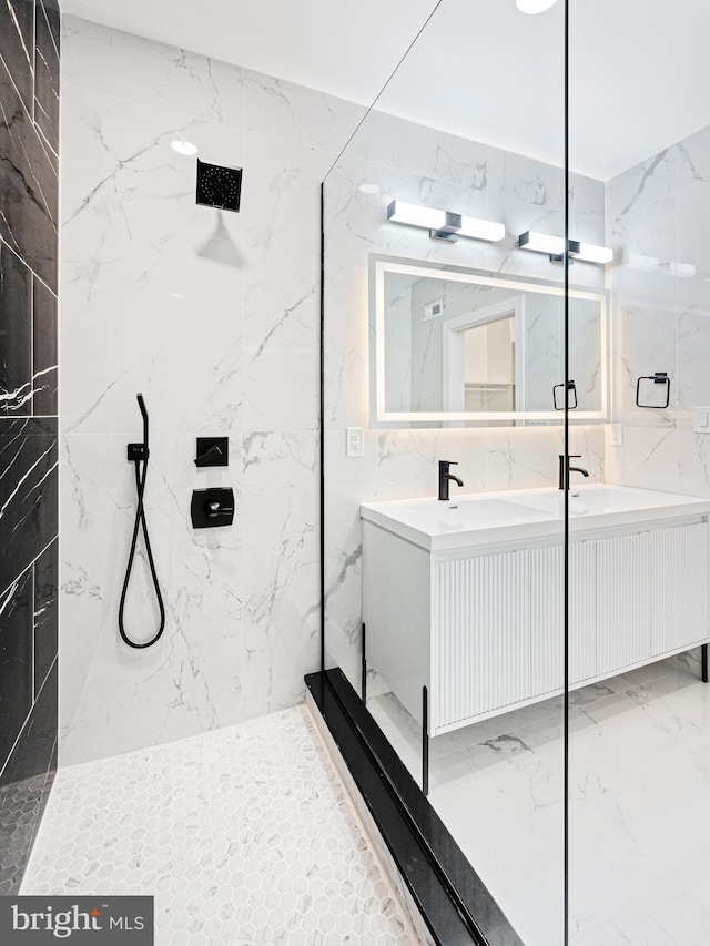 bathroom featuring tile walls, vanity, and tiled shower