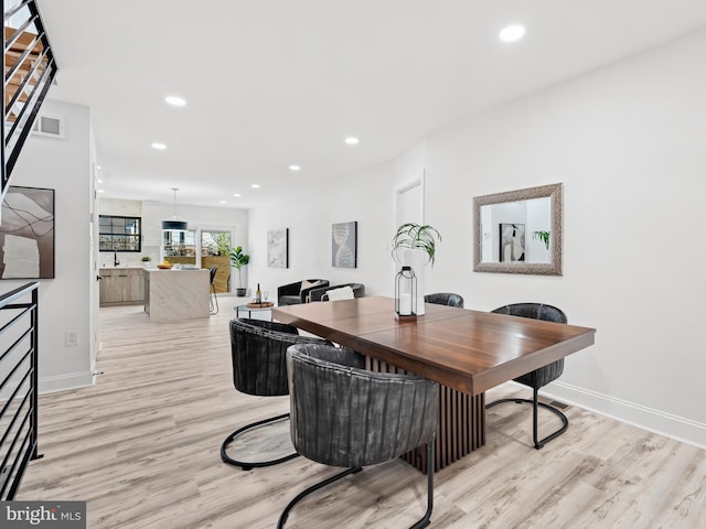 dining space featuring light hardwood / wood-style floors