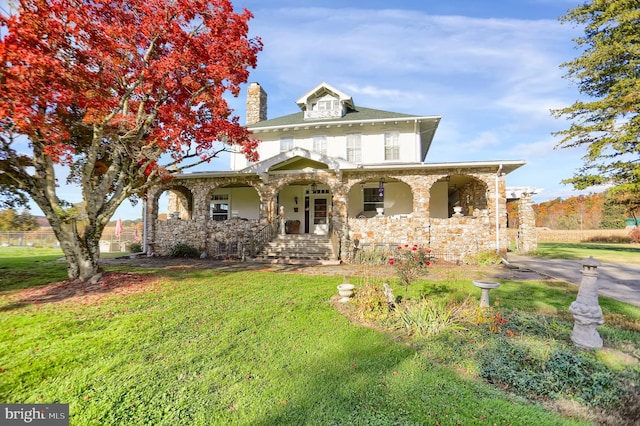 view of front of property featuring a front lawn and covered porch