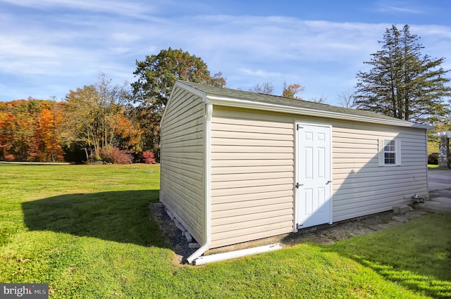 view of outbuilding with a lawn