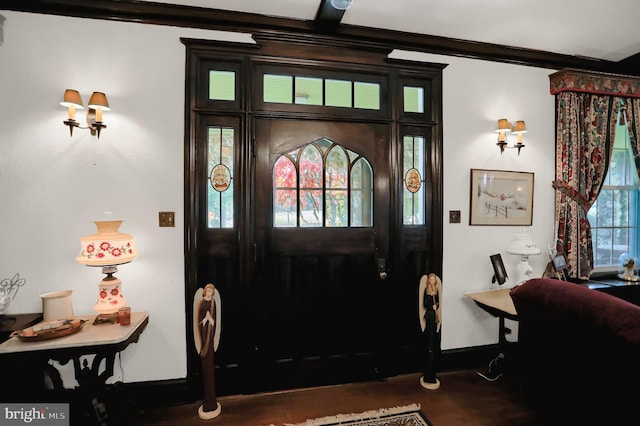 entryway featuring crown molding and dark wood-type flooring