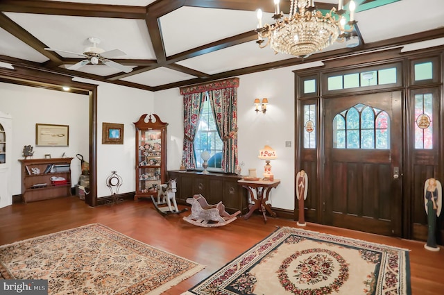 foyer with a wealth of natural light, wood finished floors, ceiling fan with notable chandelier, and baseboards