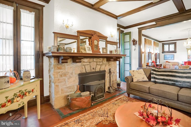 living room featuring coffered ceiling, hardwood / wood-style flooring, ornamental molding, an inviting chandelier, and a fireplace