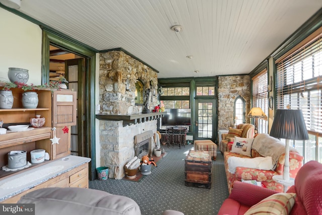 carpeted living room with wooden ceiling and a fireplace