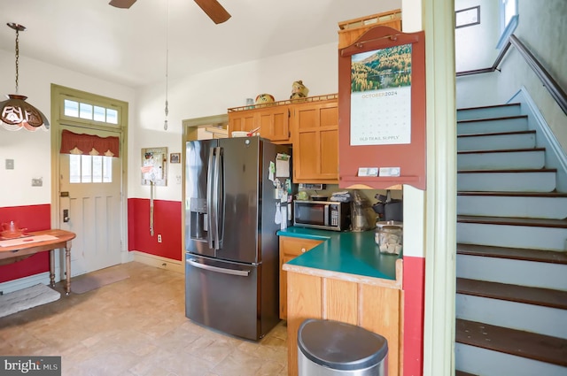 kitchen with ceiling fan, stainless steel appliances, and hanging light fixtures