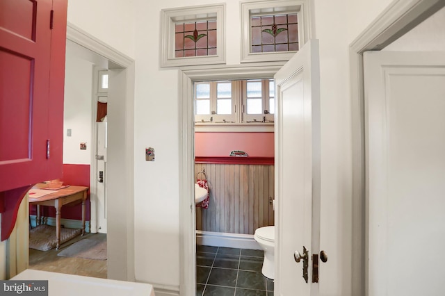 bathroom with toilet and tile patterned floors