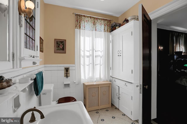 bathroom featuring sink, tile walls, and tile patterned flooring