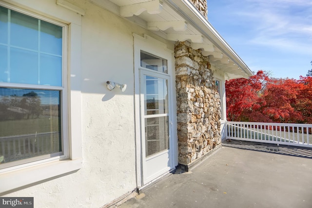 view of home's exterior featuring stucco siding and stone siding