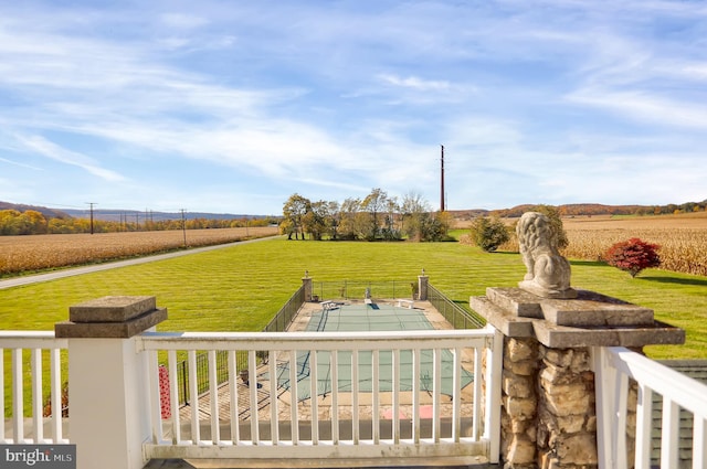 view of yard featuring fence and a rural view
