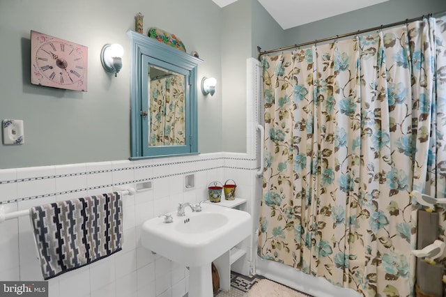 bathroom with tile walls and sink