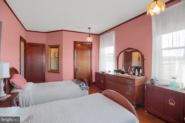 bedroom with dark wood-type flooring and ornamental molding