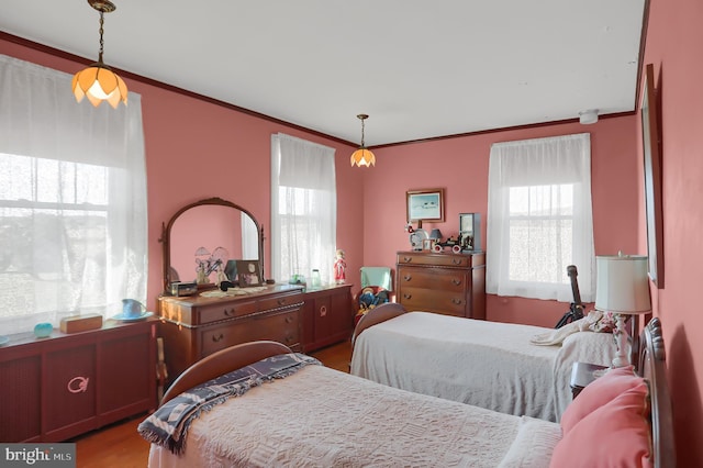 bedroom with ornamental molding and hardwood / wood-style flooring