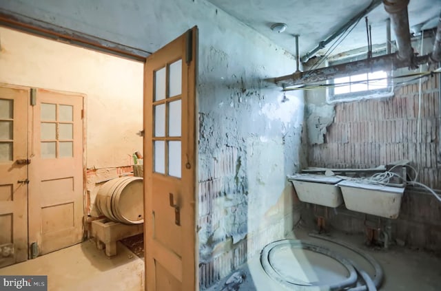 bathroom featuring toilet and concrete flooring