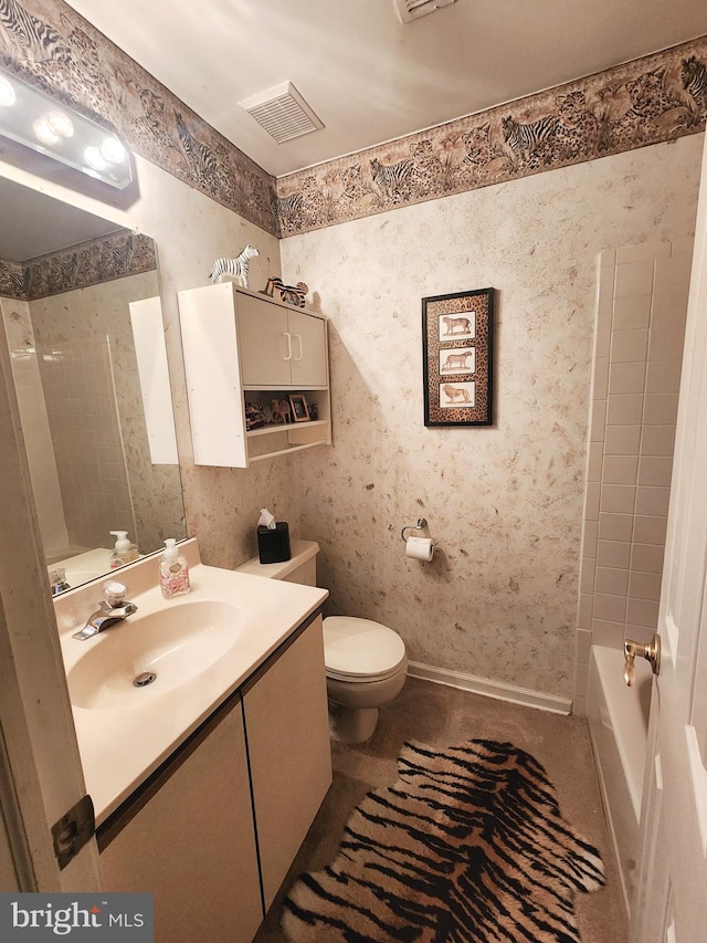 full bathroom featuring vanity, toilet, and tiled shower / bath