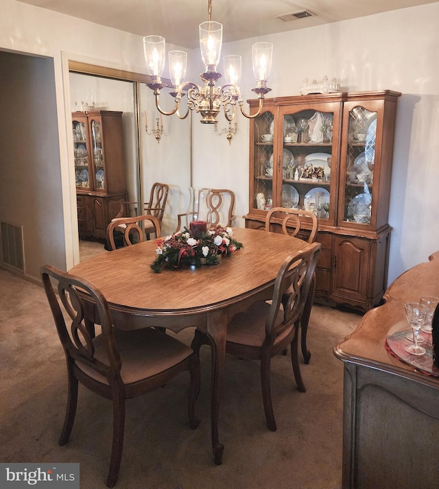 dining room featuring light colored carpet and a chandelier