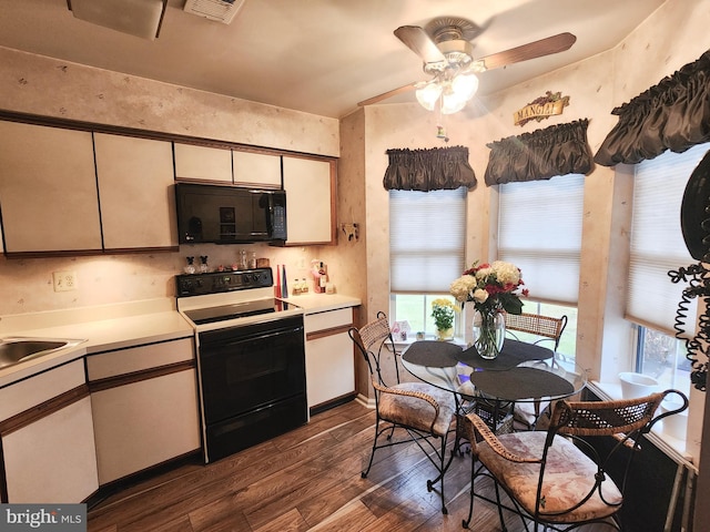 kitchen with electric stove, sink, ceiling fan, dark hardwood / wood-style flooring, and white cabinetry