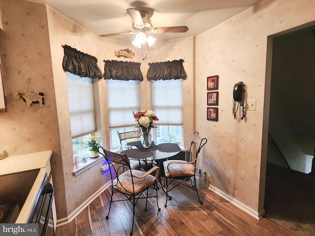 dining area with dark hardwood / wood-style flooring and ceiling fan