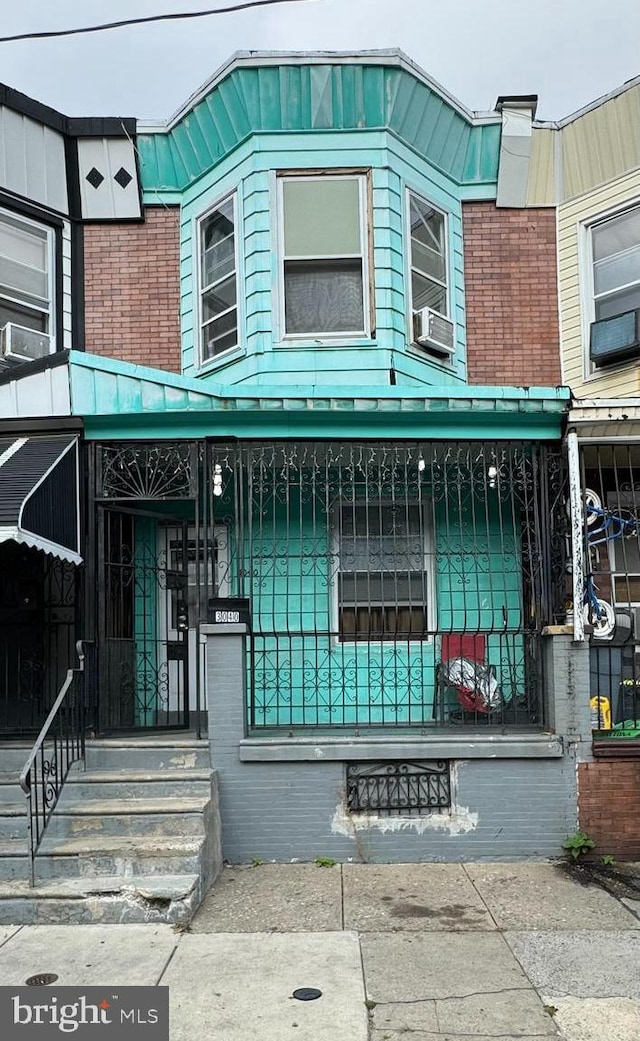 view of front of house with cooling unit and a porch