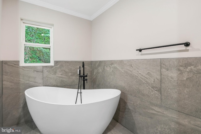 bathroom with crown molding, tile walls, and a bath