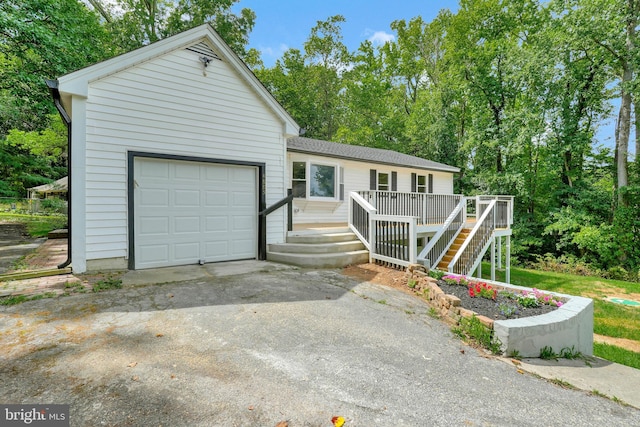 view of front of home featuring a wooden deck and a garage