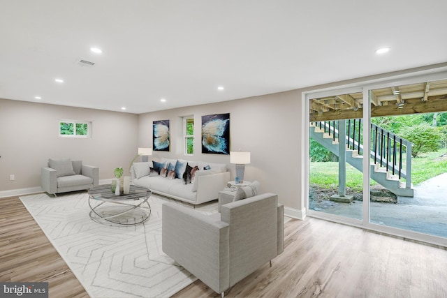 living room featuring a wealth of natural light and light hardwood / wood-style flooring