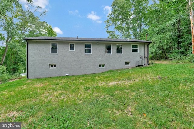 back of house with a yard and cooling unit