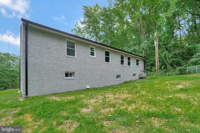 view of home's exterior featuring a yard and central AC unit