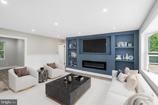 living room featuring hardwood / wood-style flooring and built in features