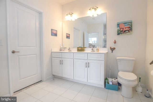 bathroom with tile patterned flooring, vanity, toilet, and a shower with shower door