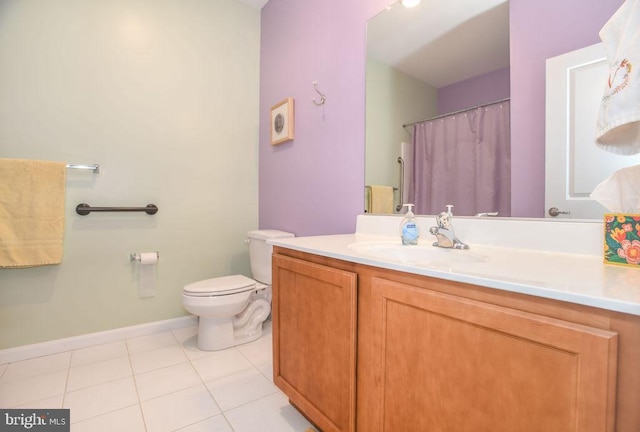 bathroom with tile patterned flooring, vanity, and toilet