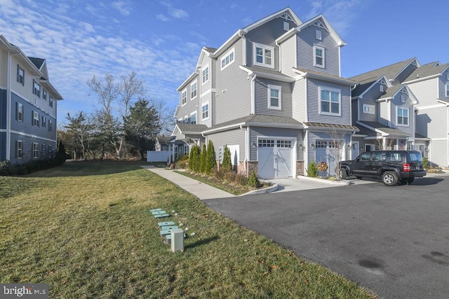 view of front of house with a front yard and a garage