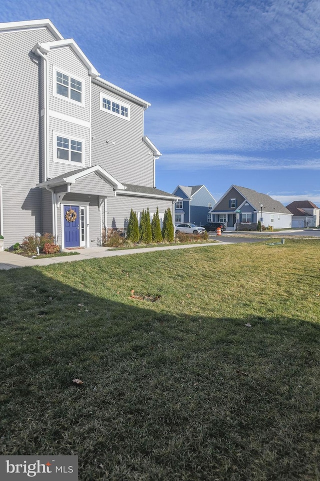 rear view of house featuring a yard