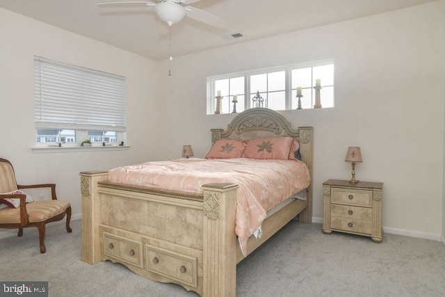 carpeted bedroom featuring ceiling fan and multiple windows