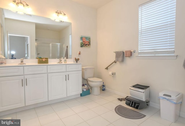 bathroom featuring tile patterned floors, a shower with door, vanity, and toilet