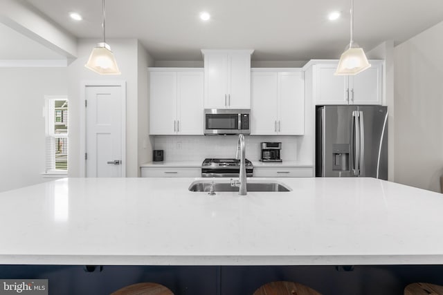 kitchen with a spacious island, hanging light fixtures, and stainless steel appliances